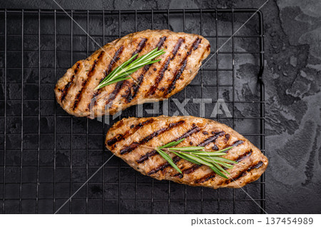 Grilled kofta kebabs made from spiced minced meat, perfectly grilled and served with fresh herbs and tangy sauce. black background. top view 137454989