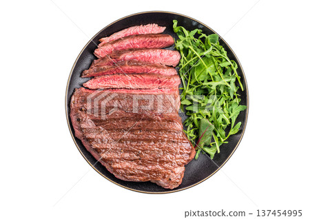 Juicy grilled top sirloin on a plate, accompanied by seasonal greens for a delicious meal. isolated on white background. top view 137454995