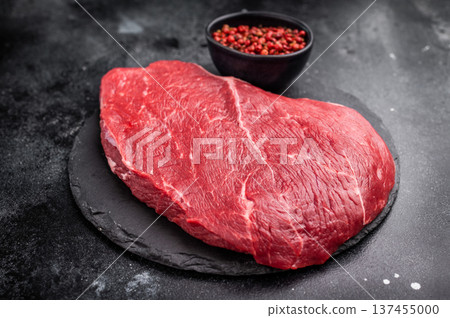 Fresh raw top sirloin steak, beautifully marbled and ready for grilling, perfect for meat lovers seeking quality. black background. top view 137455000