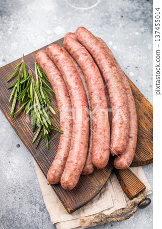Freshly made raw sausage displayed elegantly, perfect for gourmet cooking or casual gatherings with friends. grey background. top view Freshly made raw sausage displayed elegantly, perfect for gourmet cooking or casual gatherings with friends. grey background. top view 137455014