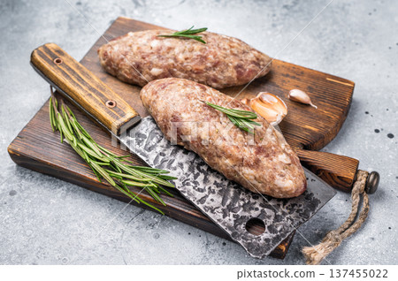 Succulent raw kofta kebab pieces marinated in spices, ideal for grilling enthusiasts looking to elevate their barbecue game. grey background. top view Succulent raw kofta kebab pieces marinated in spices, ideal for grilling enthusiasts looking to elevate their barbecue game. grey background. top view 137455022