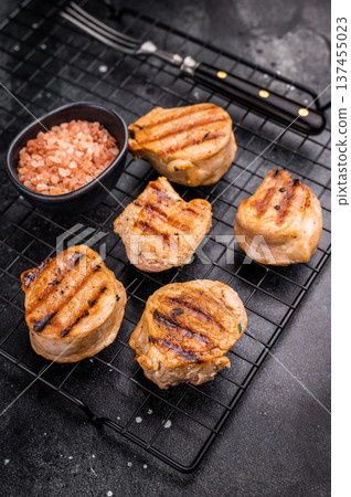 BBQ grilled pork medallions steaks, tenderloin fillet meat. black background. top view BBQ grilled pork medallions steaks, tenderloin fillet meat. black background. top view 137455023