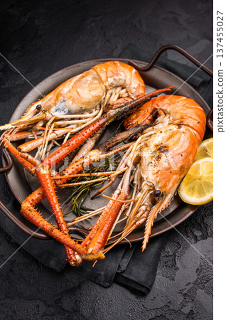 Succulent grilled rosenbergii prawn shrimp, perfectly charred and bursting with flavor, ideal for seafood lovers. black background. top view Succulent grilled rosenbergii prawn shrimp, perfectly charred and bursting with flavor, ideal for seafood lovers. black background. top view 137455027