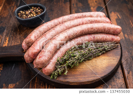 Uncooked sausage on a wooden board, a must have ingredient for delicious homemade recipes and comfort food. wooden background. top view Uncooked sausage on a wooden board, a must have ingredient for delicious homemade recipes and comfort food. wooden background. top view 137455030