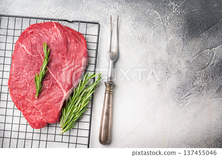 A close up of raw top sirloin beef steak, showcasing its rich color and tender texture, ideal for gourmet cooking. white background. top view A close up of raw top sirloin beef steak, showcasing its rich color and tender texture, ideal for gourmet cooking. white background. top view 137455046