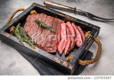Close up of a perfectly grilled rump or top sirloin beef steak, highlighting its tenderness and flavorful crust, ideal for meat enthusiasts. white background. top view Close up of a perfectly grilled rump or top sirloin beef steak, highlighting its tenderness and flavorful crust, ideal for meat enthusiasts. white background. top view 137455047