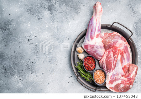 Whole fresh lamb mutton shoulder, inviting you to prepare a delicious roast that will impress your guests. white background. top view Whole fresh lamb mutton shoulder, inviting you to prepare a delicious roast that will impress your guests. white background. top view 137455048
