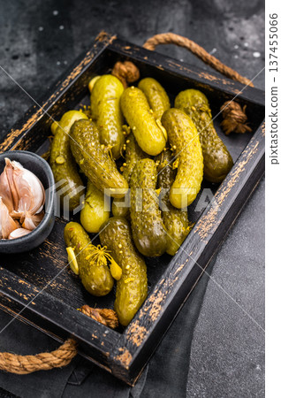 Sweet and tangy pickled cucumbers, ideal for enhancing burgers and wraps with a burst of flavor. black background. top view 137455066