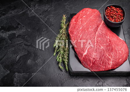 Juicy raw top sirloin cut, highlighting its marbling and freshness, perfect for your next barbecue or dinner party. black background. top view Juicy raw top sirloin cut, highlighting its marbling and freshness, perfect for your next barbecue or dinner party. black background. top view 137455076