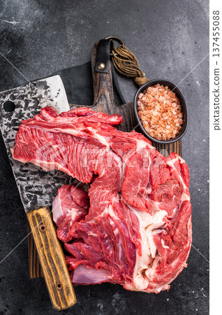 Beautifully marbled raw beef neck meat, perfect for enhancing your favorite recipes with rich flavors. black background. top view Beautifully marbled raw beef neck meat, perfect for enhancing your favorite recipes with rich flavors. black background. top view 137455088