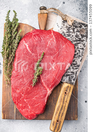 High quality raw top sirloin or rump beef steak, showcasing its rich flavor profile and tenderness, ideal for delicious meals. grey background. top view 137455099