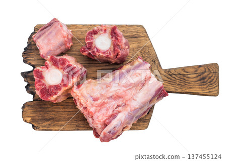 Raw lamb oxtail pieces on wooden board with herbs and peppercorns over isolated background with copy space 137455124