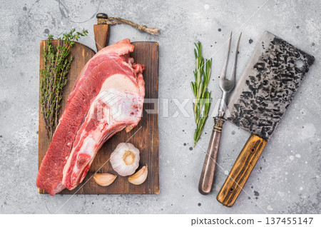 Bone-in beef cut with garlic and rosemary on wooden board, perfect for slow cooking, bone broth and deeply flavored homemade stock. Bone-in beef cut with garlic and rosemary on wooden board, perfect for slow cooking, bone broth and deeply flavored homemade stock. 137455147
