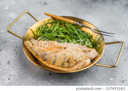 Pan fried pike perch fillet served with fresh greens in skillet, healthy freshwater white fish meal. Pan fried pike perch fillet served with fresh greens in skillet, healthy freshwater white fish meal. 137455163