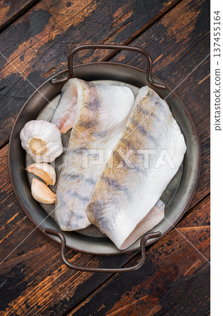 Raw pike perch fillets with skin on rustic wooden background, fresh lean freshwater white fish with garlic, ready for cooking. Raw pike perch fillets with skin on rustic wooden background, fresh lean freshwater white fish with garlic, ready for cooking. 137455164