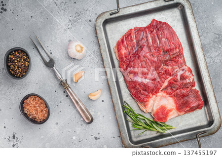 Raw beef brisket on metal tray with garlic and rosemary, top view cooking preparation scene with copy space Raw beef brisket on metal tray with garlic and rosemary, top view cooking preparation scene with copy space 137455197