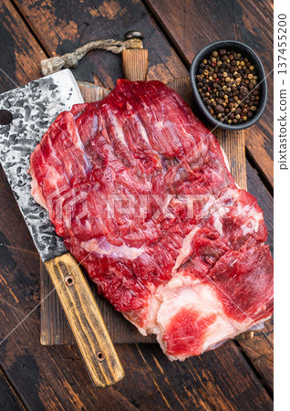 Raw beef brisket with cleaver on rustic wooden table, top view with copy space, fresh meat cut for barbecue and slow smoking Raw beef brisket with cleaver on rustic wooden table, top view with copy space, fresh meat cut for barbecue and slow smoking 137455200