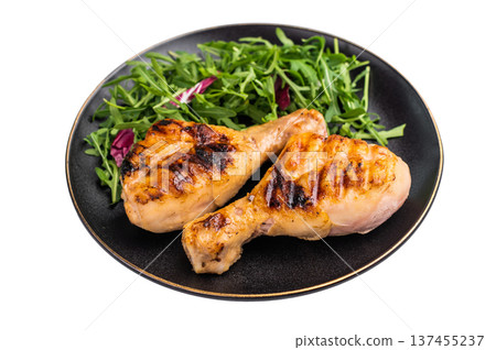 Deliciously grilled chicken legs drumsticks, featuring a crispy skin and juicy meat, a must have for any outdoor feast. isolated on white background. top view Deliciously grilled chicken legs drumsticks, featuring a crispy skin and juicy meat, a must have for any outdoor feast. isolated on white background. top view 137455237