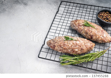 Close up of raw adana kebab meat skewers, seasoned to perfection, showcasing vibrant colors and tantalizing textures. white background. top view Close up of raw adana kebab meat skewers, seasoned to perfection, showcasing vibrant colors and tantalizing textures. white background. top view 137455288