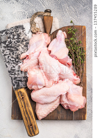 Fresh chicken wings, showcasing their natural texture, perfect for creating savory snacks or hearty meals. white background. top view Fresh chicken wings, showcasing their natural texture, perfect for creating savory snacks or hearty meals. white background. top view 137455289