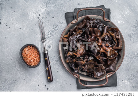 Fresh wood ear mushrooms, perfect for adding unique texture and flavor to your favorite Asian dishes. grey background. top view Fresh wood ear mushrooms, perfect for adding unique texture and flavor to your favorite Asian dishes. grey background. top view 137455295