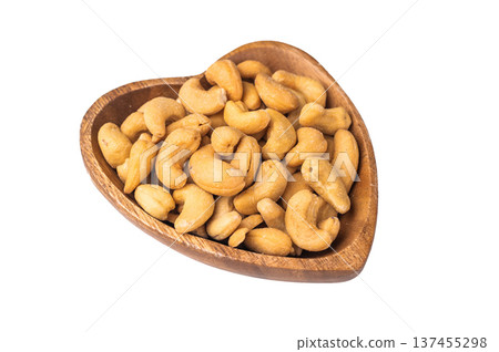 Cashew nuts in a wooden bowl on a clean white background creating a bright minimal ingredient Cashew nuts in a wooden bowl on a clean white background creating a bright minimal ingredient 137455298