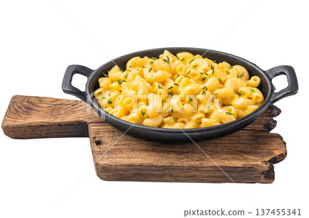 Savory mac and cheese presented in a cast iron dish, minimal white background highlights the rich texture. 137455341
