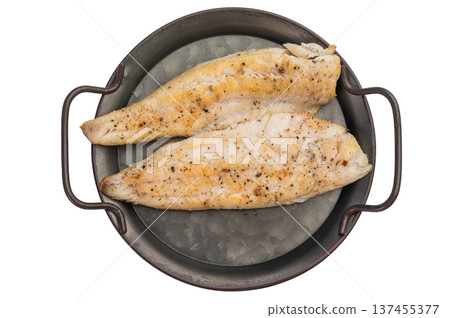 Grilled whitefish fillets with spices on a rustic metal pan over a clean white background, healthy seafood protein meal. 137455377