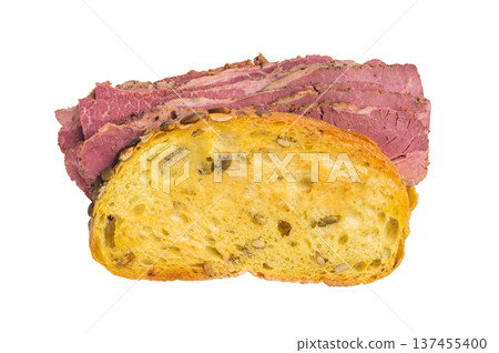 Gourmet pastrami brisket sandwich made from thin sliced cured deli meat and seed crusted bread on a bright white studio background. Gourmet pastrami brisket sandwich made from thin sliced cured deli meat and seed crusted bread on a bright white studio background. 137455400