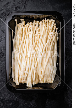 Top view of raw Enokitake (Golden Needle) mushrooms. Healthy Asian food ingredient. Perfect for food blogs and gourmet cooking concepts. Top view of raw Enokitake (Golden Needle) mushrooms. Healthy Asian food ingredient. Perfect for food blogs and gourmet cooking concepts. 137455452