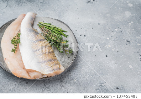 Fresh zander fillet, also called walleye or pike perch, raw white freshwater fish prepared with thyme and rosemary. Fresh zander fillet, also called walleye or pike perch, raw white freshwater fish prepared with thyme and rosemary. 137455495