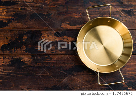Golden brass style frying pan with two handles on rustic wooden table, top view kitchen cookware with copy space Golden brass style frying pan with two handles on rustic wooden table, top view kitchen cookware with copy space 137455675