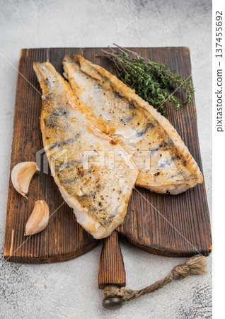 Lean fried white fish with fresh herbs and natural seasoning, high protein healthy food concept. Lean fried white fish with fresh herbs and natural seasoning, high protein healthy food concept. 137455692