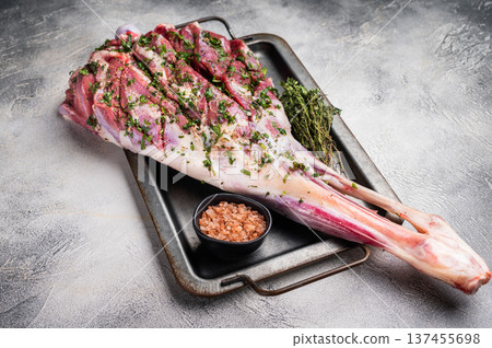 Marinated with herbs and olive oil raw lamb leg. white background. top view Marinated with herbs and olive oil raw lamb leg. white background. top view 137455698