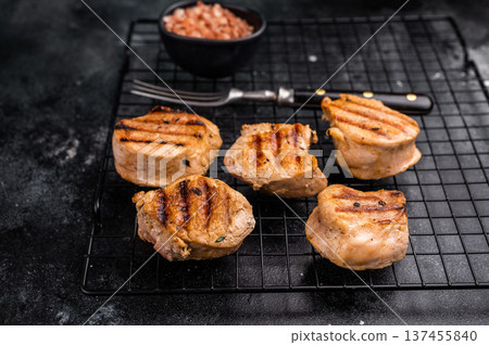 BBQ grilled pork medallions steaks, tenderloin fillet meat. black background. top view BBQ grilled pork medallions steaks, tenderloin fillet meat. black background. top view 137455840