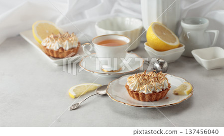 Meringue lemon tart on a white table. 137456040
