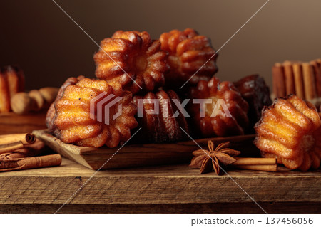 Cinnamon cakes with ingredients on an old wooden table. Cinnamon cakes with ingredients on an old wooden table. 137456056