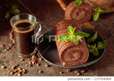Homemade chocolate cake and a mug of black coffee. Homemade chocolate cake and a mug of black coffee. 137456064