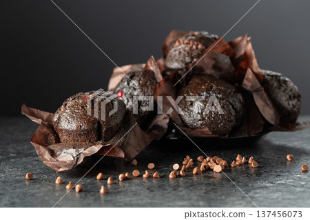 Dark chocolate muffins on a black table. Dark chocolate muffins on a black table. 137456073