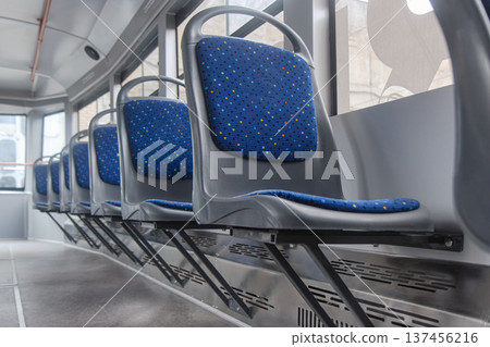 Row of blue passenger seats inside a modern tram Row of blue passenger seats inside a modern tram 137456216