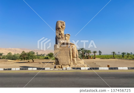 Colossi of Memnon, two massive stone statues representing the pharaoh, Luxor, Egypt Colossi of Memnon, two massive stone statues representing the pharaoh, Luxor, Egypt 137456725