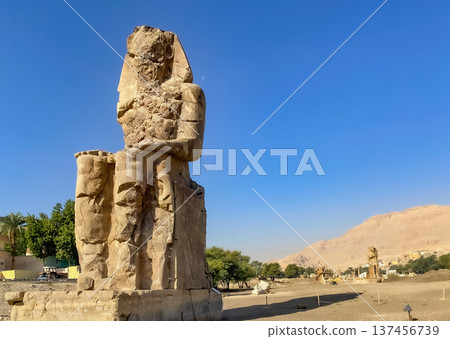 Colossi of Memnon, two massive stone statues representing the pharaoh, Luxor, Egypt Colossi of Memnon, two massive stone statues representing the pharaoh, Luxor, Egypt 137456739
