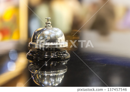 Vintage Hotel Reception Service Bell on Counter with Warm Bokeh Background Vintage Hotel Reception Service Bell on Counter with Warm Bokeh Background 137457546