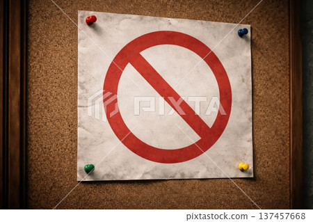 A sheet of paper with a red prohibitory sign on a cork board. A sheet of paper with a red prohibitory sign on a cork board. 137457668