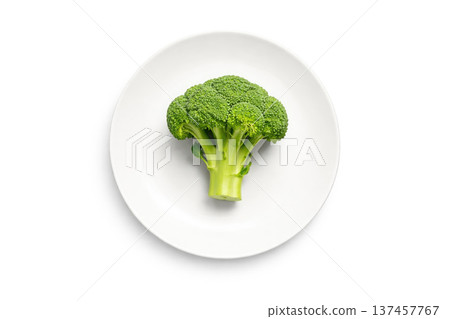 Broccoli on a white plate on a minimalist background. Broccoli on a white plate on a minimalist background. 137457767