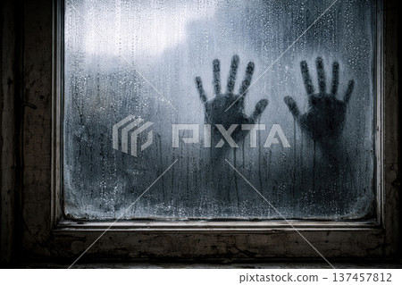 Handprints on a foggy window pane in a dark room. Space for text. Handprints on a foggy window pane in a dark room. Space for text. 137457812