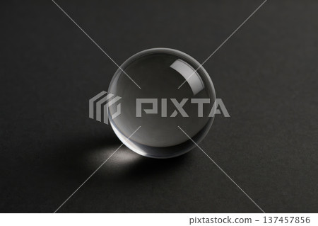 Transparent glass sphere on a dark background. Space for text. 137457856