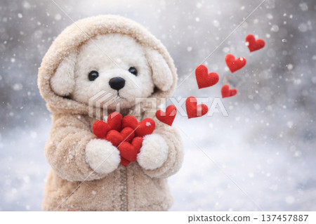 A teddy bear in winter clothes holds red hearts. A teddy bear in winter clothes holds red hearts. 137457887