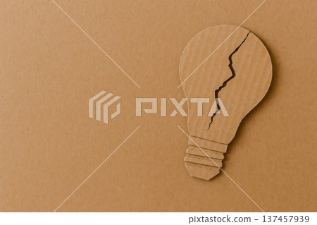 A cracked cardboard light bulb on a clean background. A cracked cardboard light bulb on a clean background. 137457939