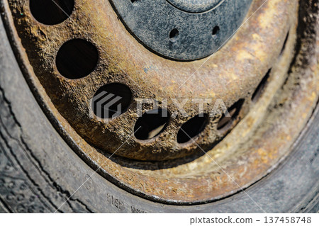 Old rusty car wheel rim closeup 137458748